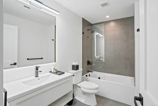 a bathroom with a toilet a sink and bathtub