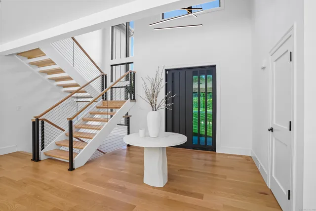 a view of entryway with stairs and wooden floor