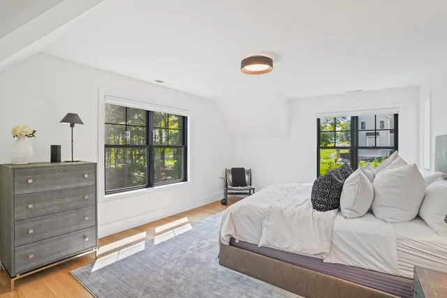 a bedroom with a large bed and a window