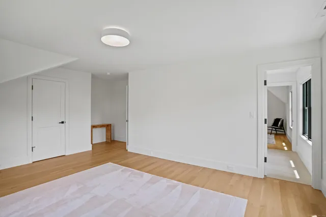 a view of a room with wooden floor and bathroom