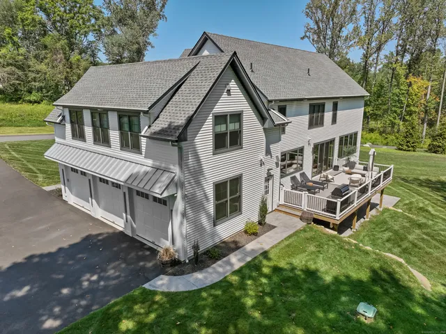 a aerial view of a house with a yard table and chairs