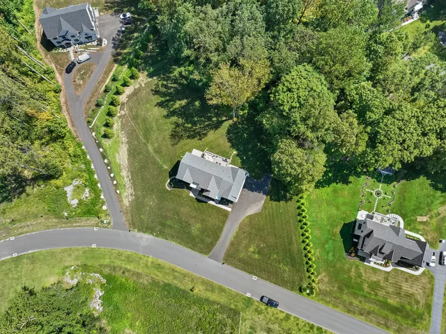 an aerial view of a house with a yard basket ball court and outdoor seating