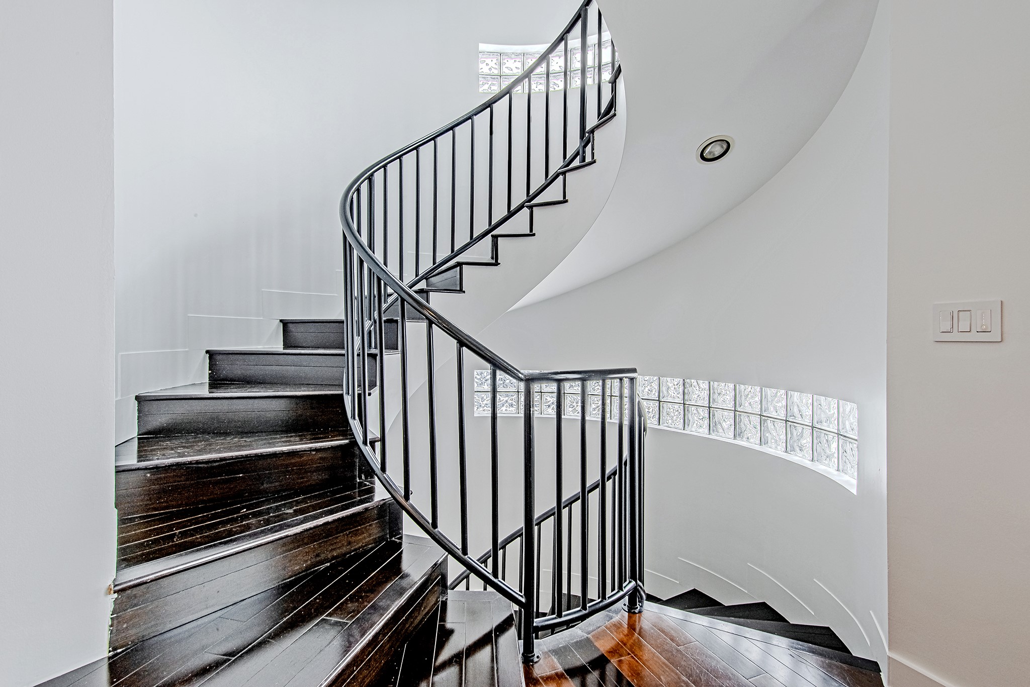 2025 Colquitt Street, Unit E Houston, TX 77098 - Photo 14 of 29 Sculptural spiral staircase serving as a standout architectural centerpiece.