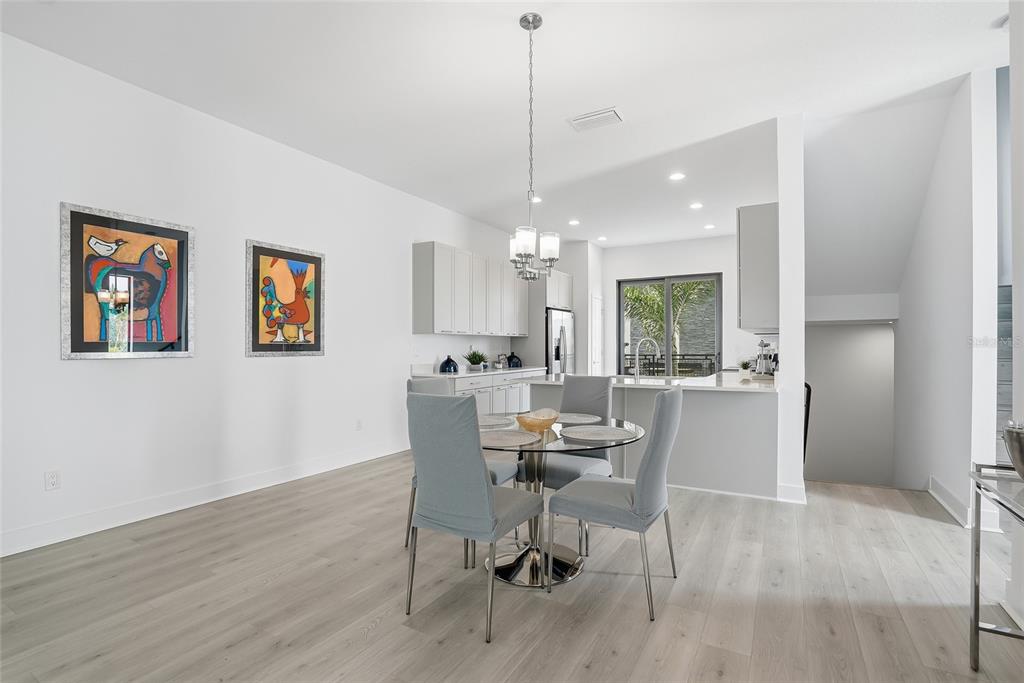 4810 West McElroy Avenue, Unit 30 Tampa, FL 33611 - Photo 12 of 43 a view of a dining room with furniture window and wooden floor