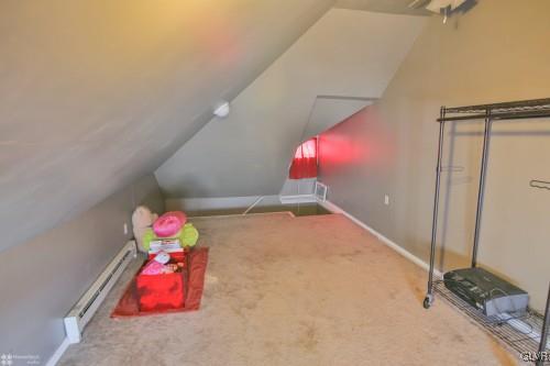 44 Easton Road Nazareth, PA 18064 - Photo 17 of 22 a bedroom with a bed and a chandelier