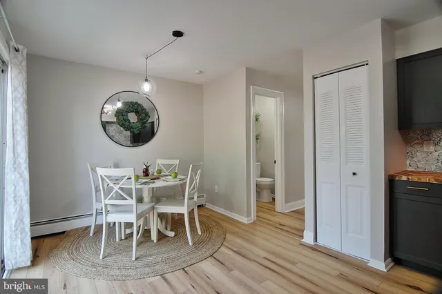 a view of a dining room with furniture wooden floor and a chandelier