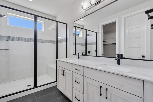 a bathroom with a double vanity sink and mirror