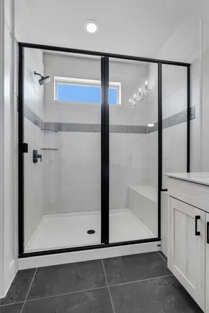 a bathroom with a glass shower door