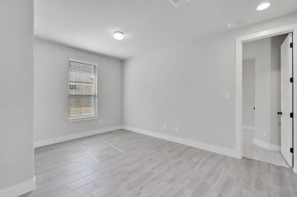a view of room with window and wooden floor