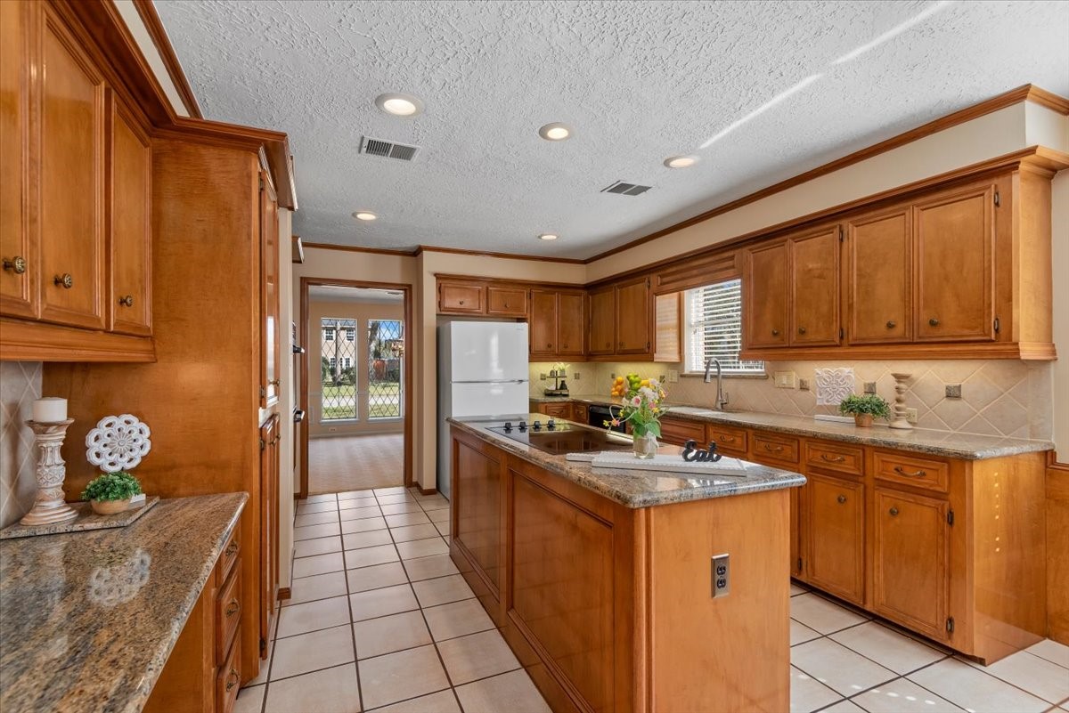 16707 Rugby Court Spring, TX 77379 - Photo 13 of 48 The kitchen also offers a separate workspace which is perfect for doing homework or it could be used as a small office space. You will not run out of storage and workspace in this kitchen!