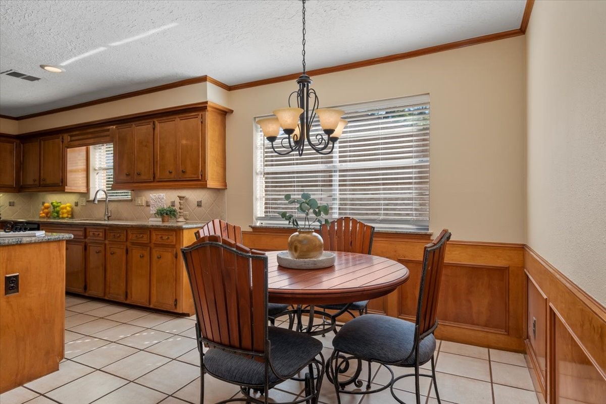 16707 Rugby Court Spring, TX 77379 - Photo 17 of 48 The wood paneling and crown molding provide a seamless transition between both kitchen and breakfast area.