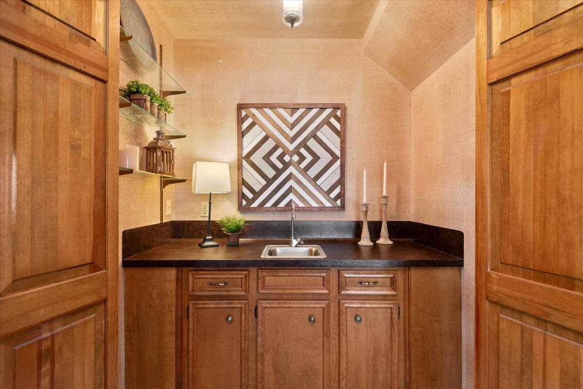 16707 Rugby Court Spring, TX 77379 - Photo 23 of 48 The living room also offers a fabulous wet bar which can be tucked away behind folding door or kept open for display.