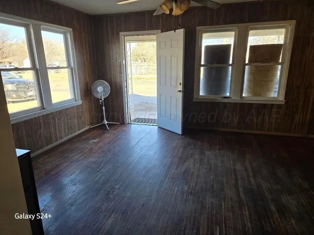 wooden floor in an empty room with a window