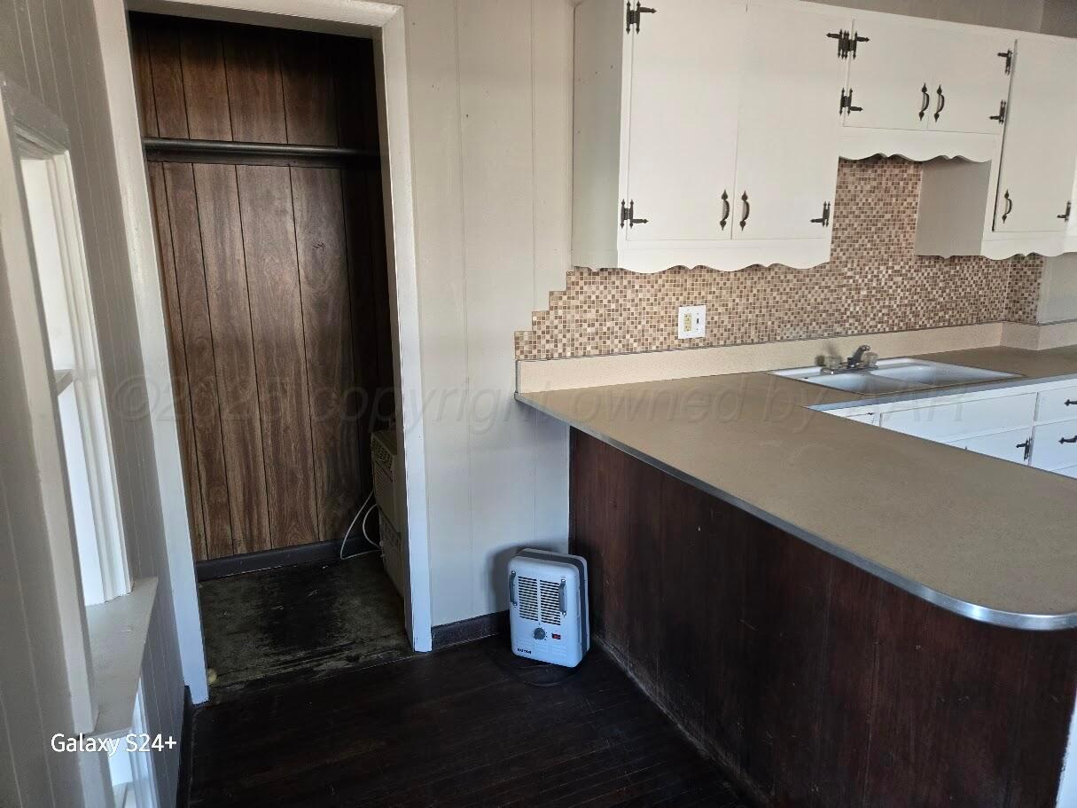 1104 South Western Street Amarillo, TX 79106 - Photo 7 of 24 a kitchen with a sink and a refrigerator