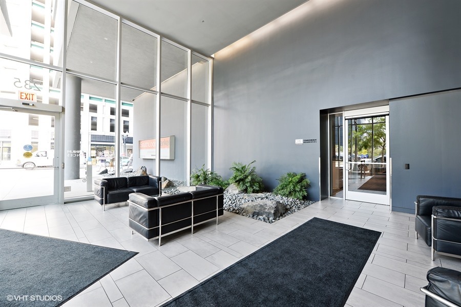235 West Van Buren Street, Unit 3420 Chicago, IL 60607 - Photo 4 of 18 a living room with furniture windows and wooden floor