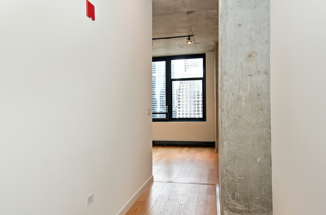 235 West Van Buren Street, Unit 3420 Chicago, IL 60607 - Photo 7 of 18 a view of an empty room with a window