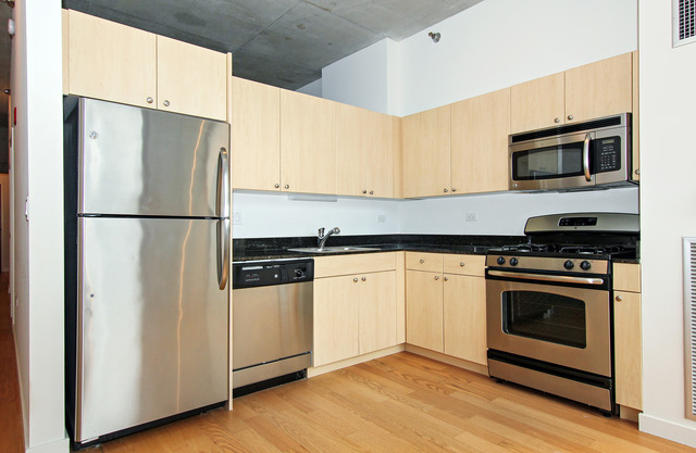 235 West Van Buren Street, Unit 3420 Chicago, IL 60607 - Photo 10 of 18 a kitchen with stainless steel appliances a refrigerator stove and microwave