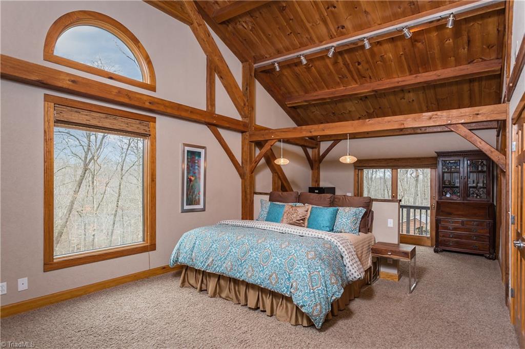 6111 Meadow Bluff Lane Oak Ridge, NC 27310 - Photo 20 of 30 The 27+ ft long master has a sitting area, sleeping area and office/exercise area (which overlooks the side yard via a private balcony). Vaulted ceiling with great views of the woods. No curtains needed!