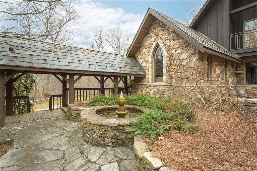 6111 Meadow Bluff Lane Oak Ridge, NC 27310 - Photo 27 of 30 Even in the winter on a not so sunny day, what a charming setting... Stone walls, bubbling fountain, timbered breezeway, overlooking your woods!
