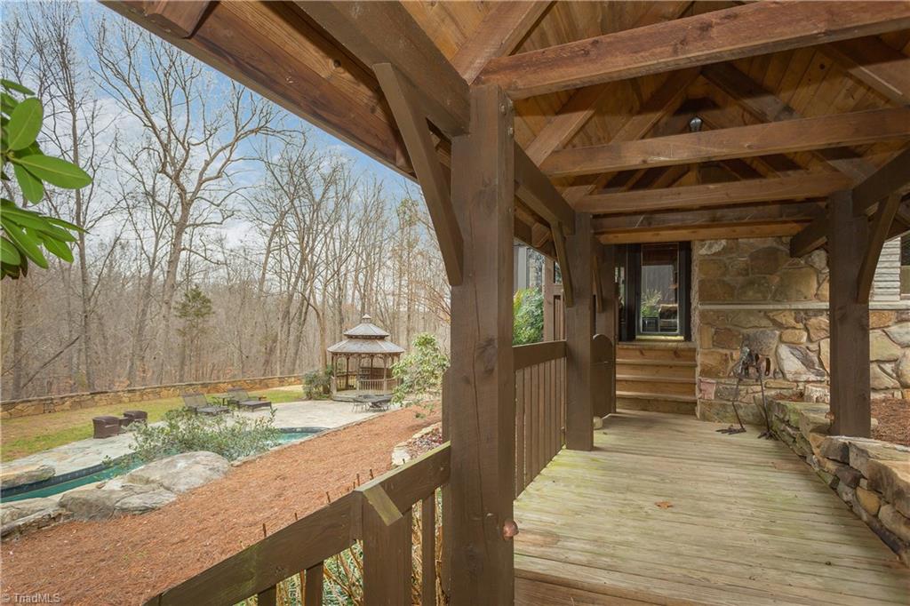 6111 Meadow Bluff Lane Oak Ridge, NC 27310 - Photo 28 of 30 The breezeway structure. Covered walkway connecting the guest house to the main dwelling. Flanked on one side with a stone wall.