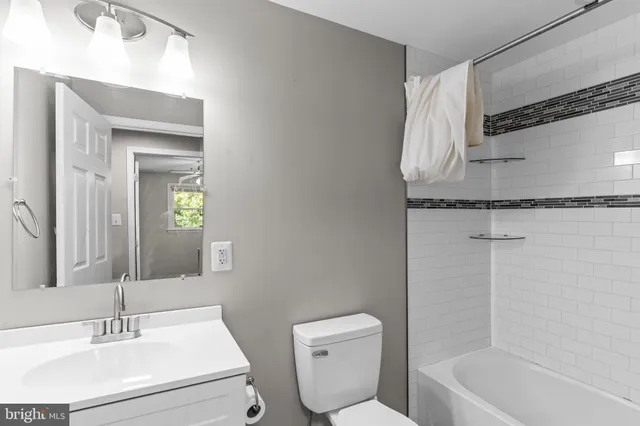 a bathroom with a sink toilet and tub