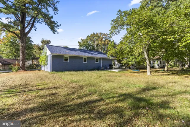 a house view with swimming pool in front of it