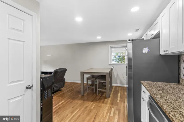 a view of a workspace with furniture and wooden floor