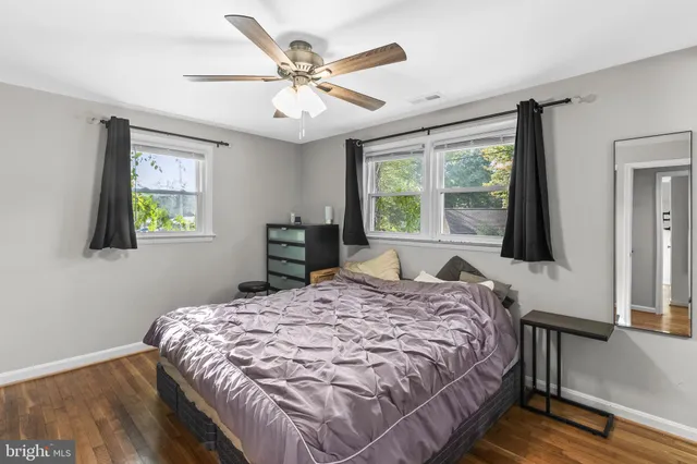 a bedroom with a large bed and a large window