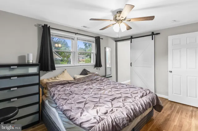 a bedroom with a large bed and a chandelier