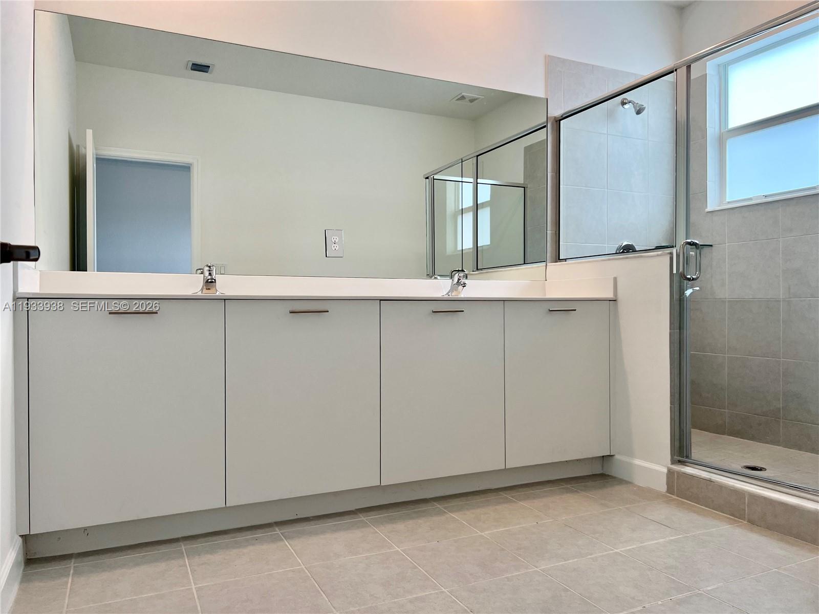 12713 Northwest 24th Avenue Miami, FL 33147 - Photo 24 of 50 a bathroom with a sink and mirror