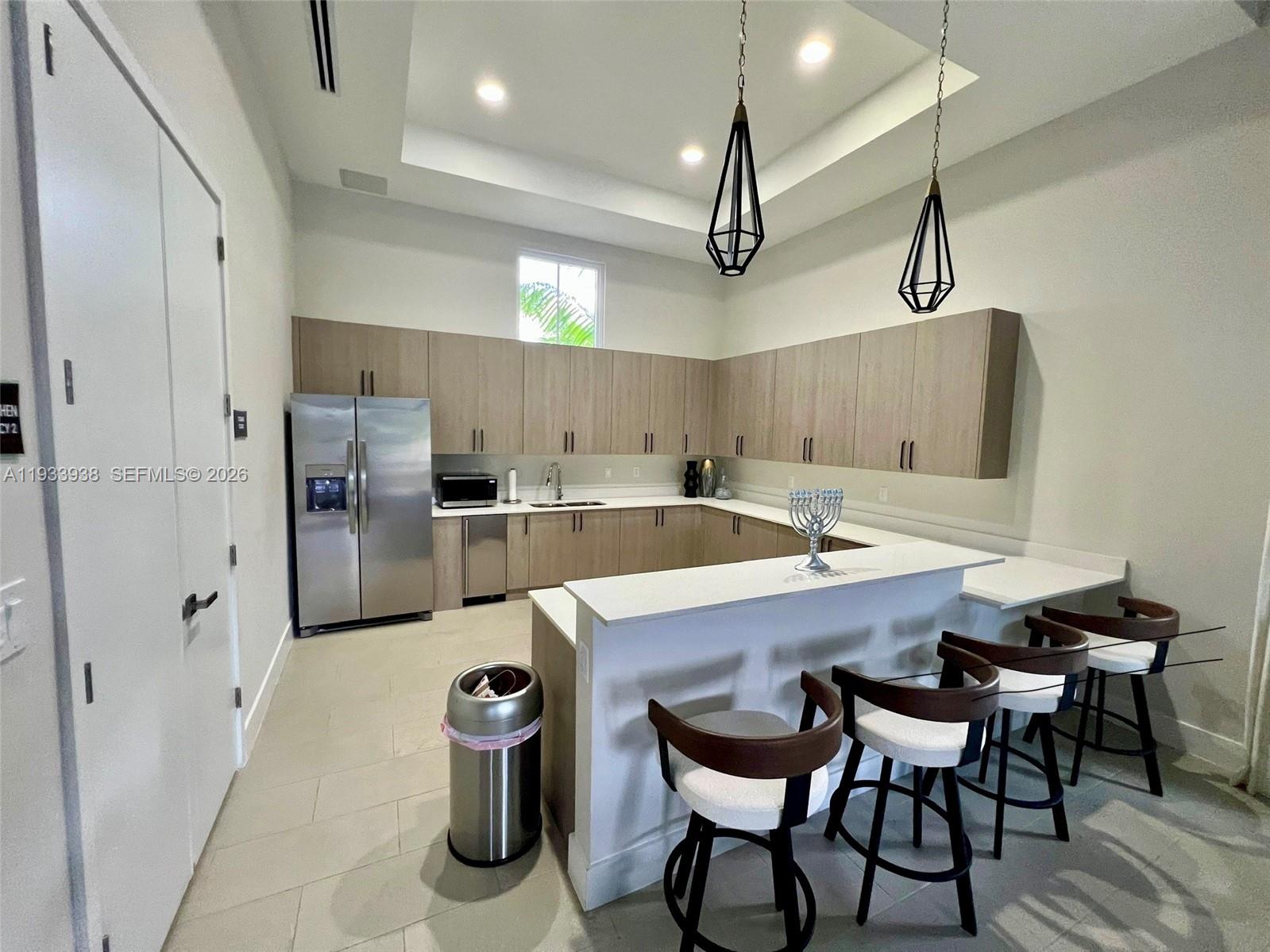 12713 Northwest 24th Avenue Miami, FL 33147 - Photo 38 of 50 a kitchen with refrigerator and chairs