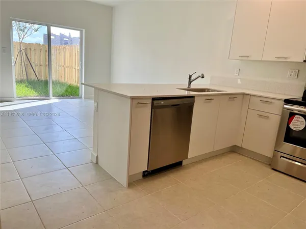 a kitchen with a refrigerator sink and microwave