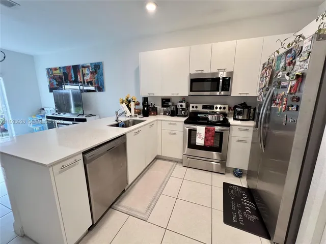 a kitchen with a refrigerator sink and microwave