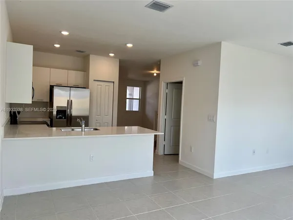 a kitchen with a sink cabinets and stainless steel appliances