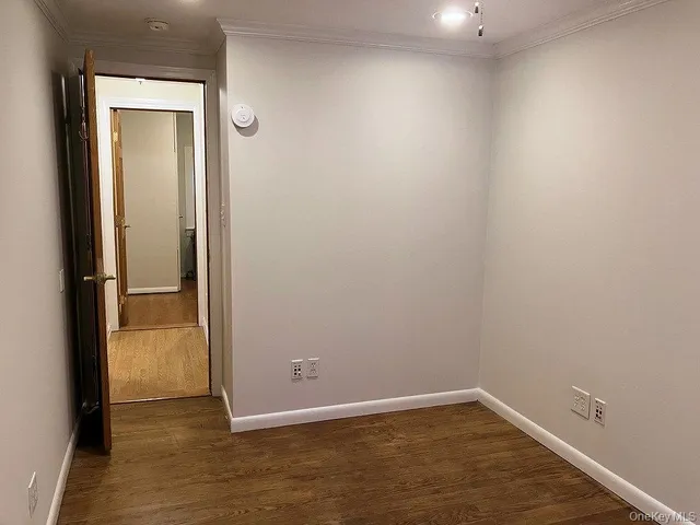 an empty room with wooden floor and sliding door