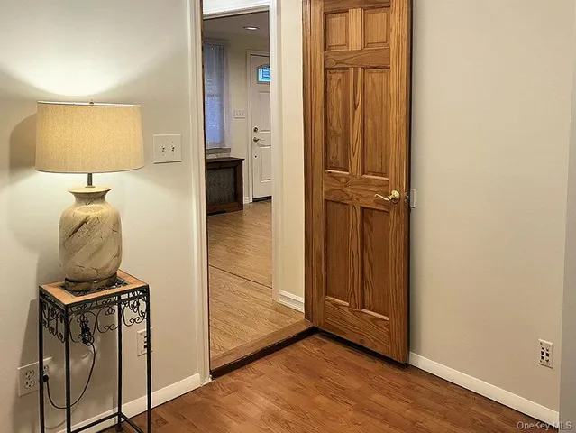 a view of a hallway with wooden floor and closet