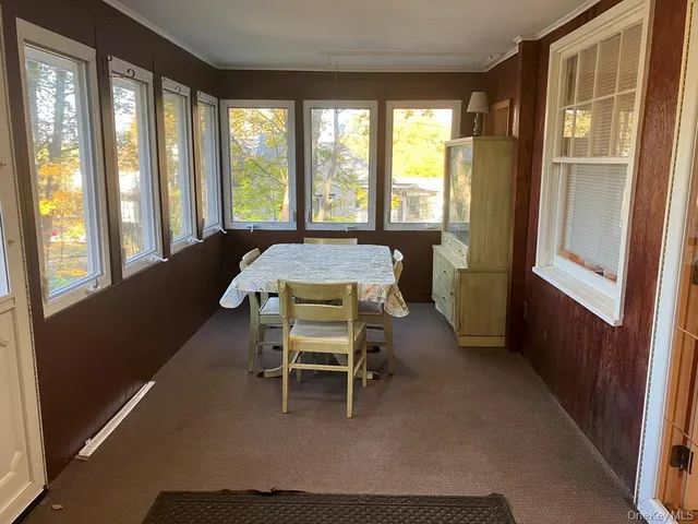 a dining room with furniture and windows