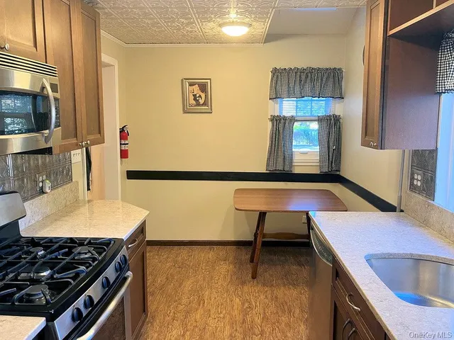 a kitchen with a sink a stove and a microwave