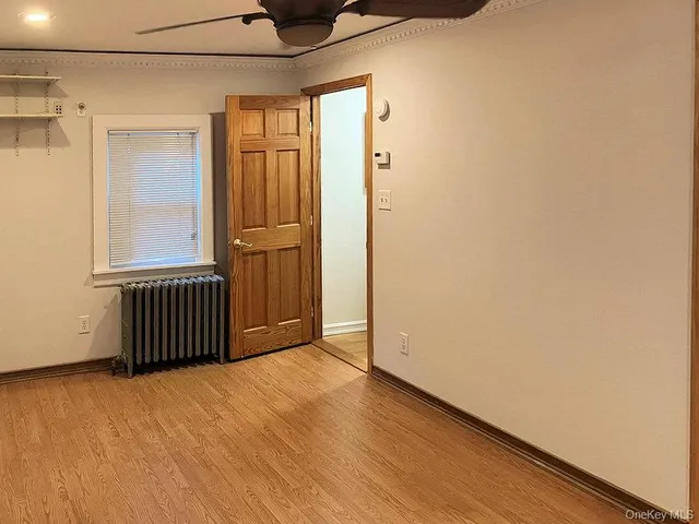 a view of a room with a wooden floor and a window