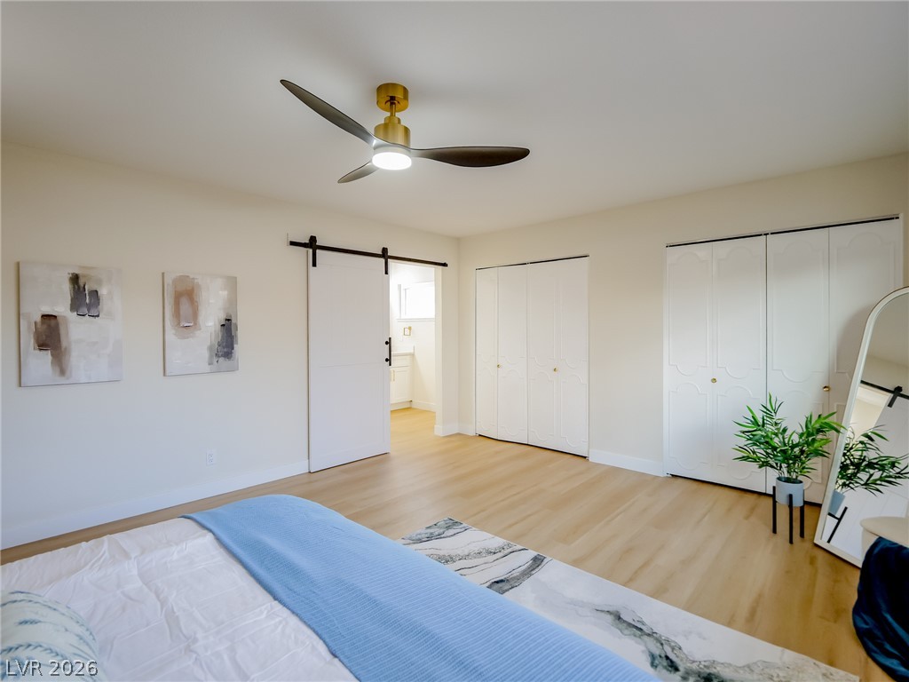 321 Lakehurst Road Las Vegas, NV 89145 - Photo 22 of 33 Double closets and a sliding barn door opening to the private ensuite bath.
