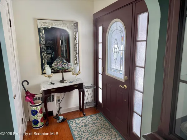 a view of hall way with mirror and furniture