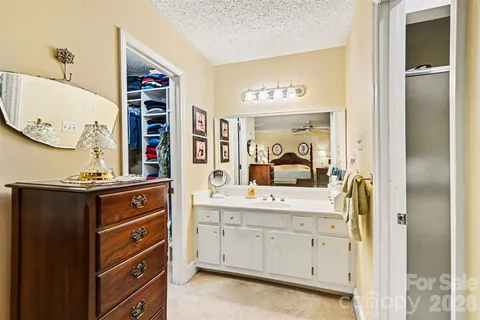 a view of cabinets with a sink and a mirror