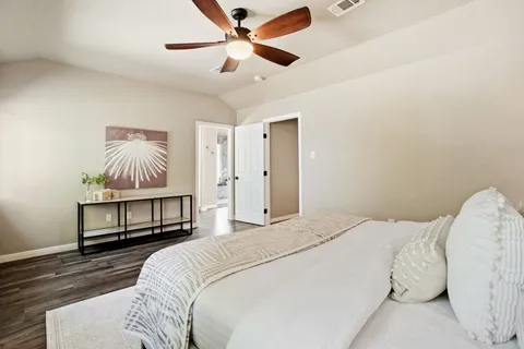 a bedroom with a bed and a chandelier