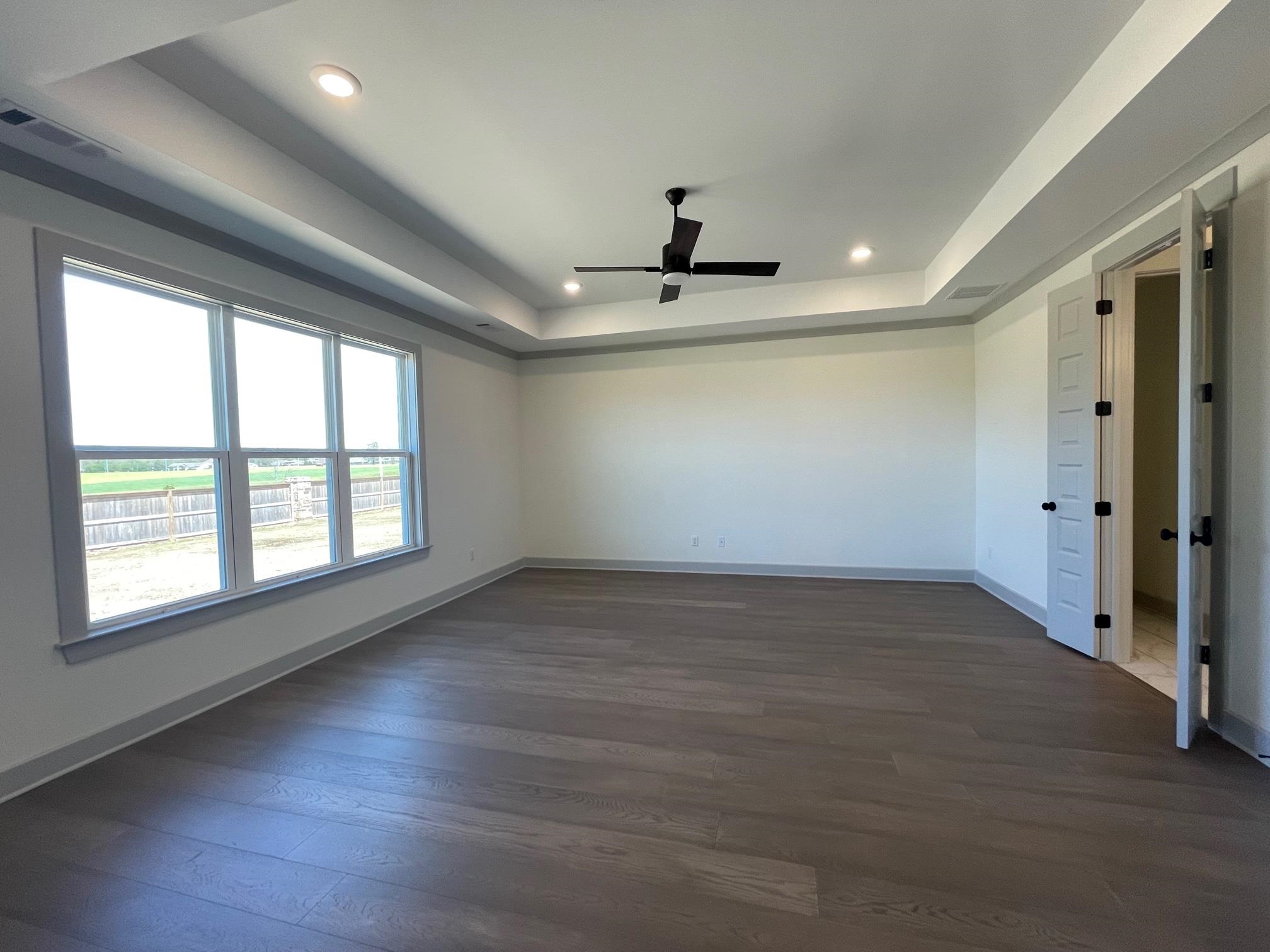 11126 Shelby Post Road Collierville, TN 38017 - Photo 14 of 21 an empty room with wooden floor and windows