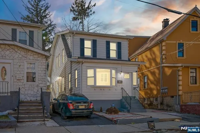 a car parked in front of a white building