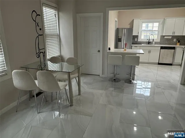 a view of a dining room with furniture and windows