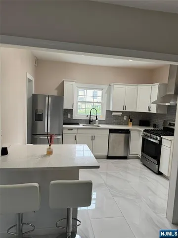 a large kitchen with granite countertop lots of counter top space