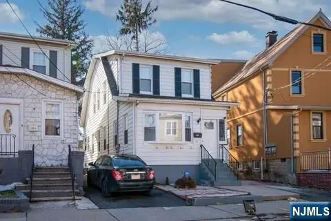 a car parked in front of a white building