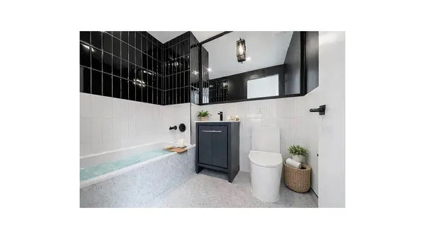 a en suite bathroom with a sink and a large mirror