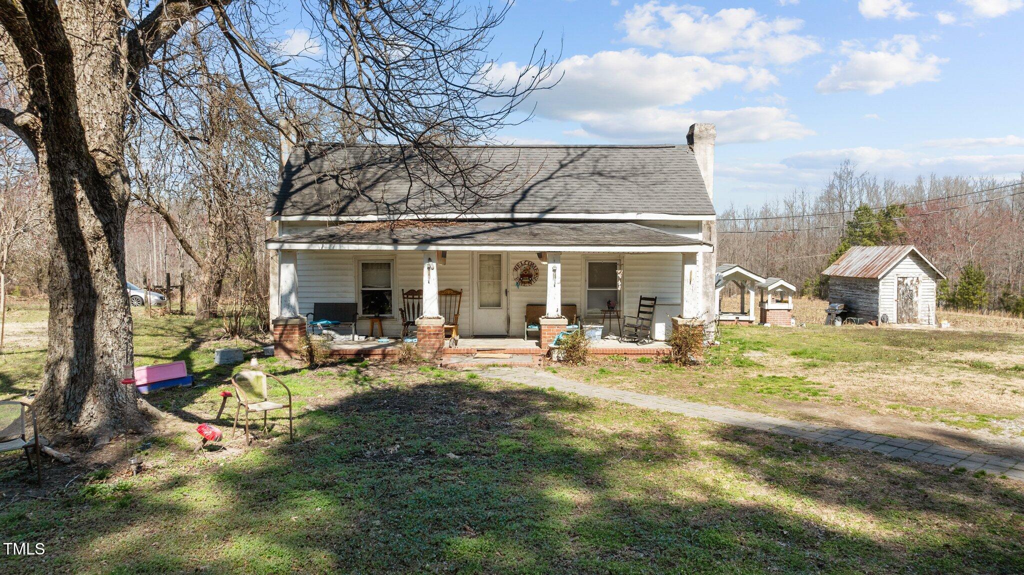 a view of swimming pool with lounge chair and dinning table under an umbrella